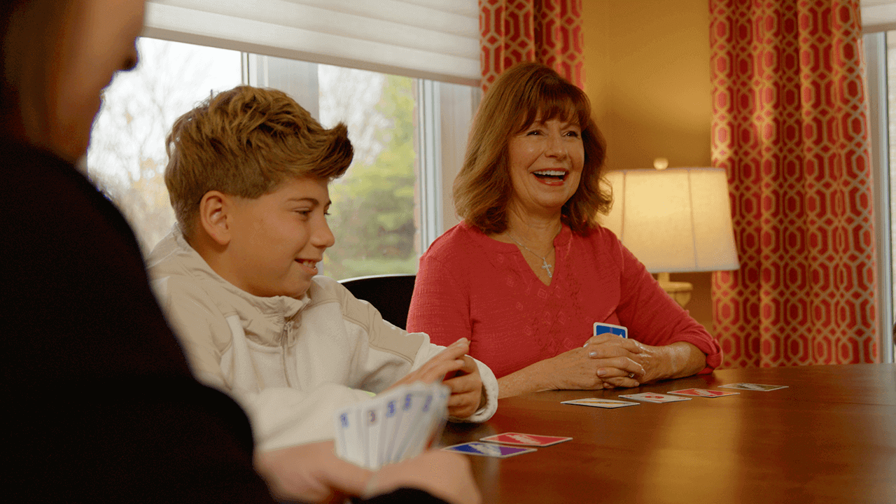 Grandma and Grandson laughing while playing SWOOP.