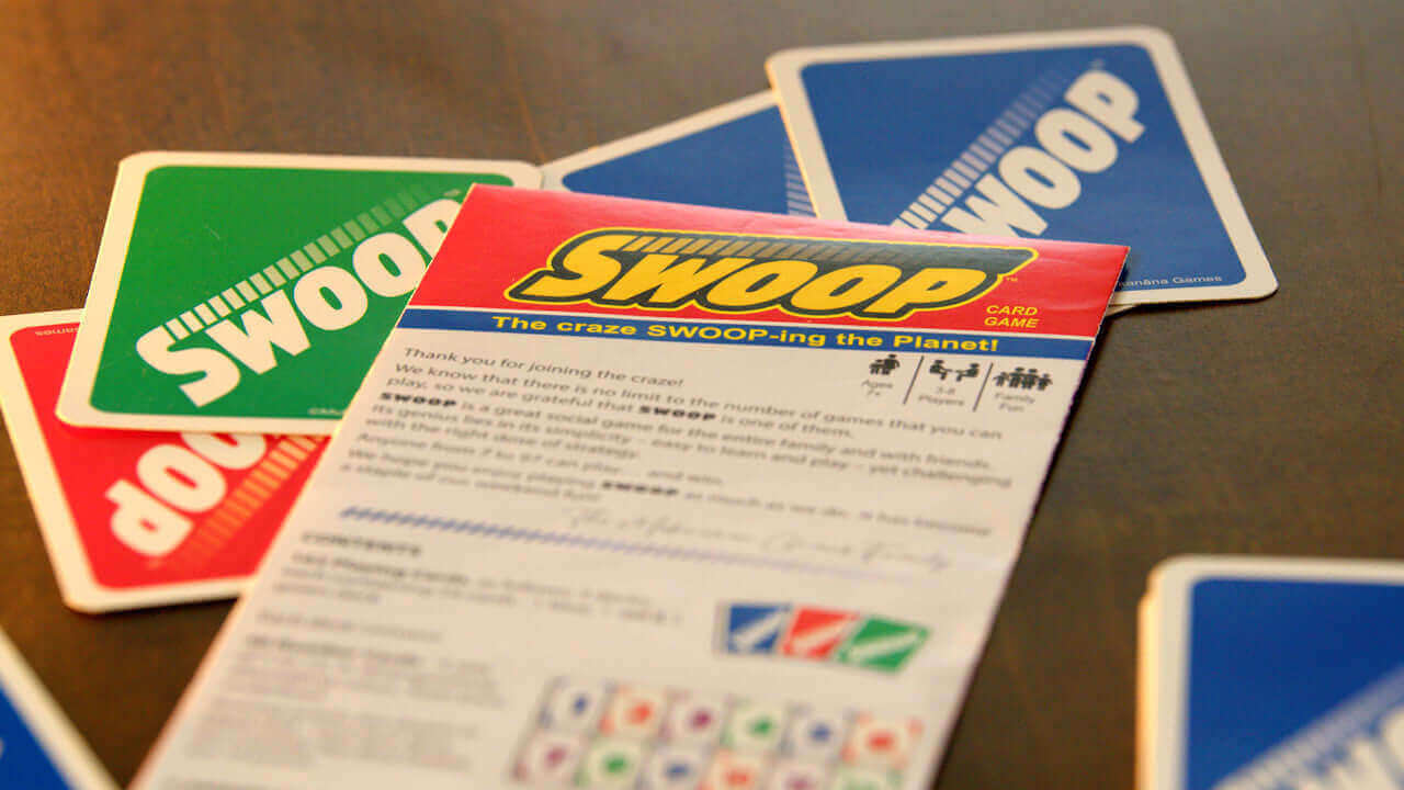 SWOOP Instruction Guide lying on a few SWOOP Cards.